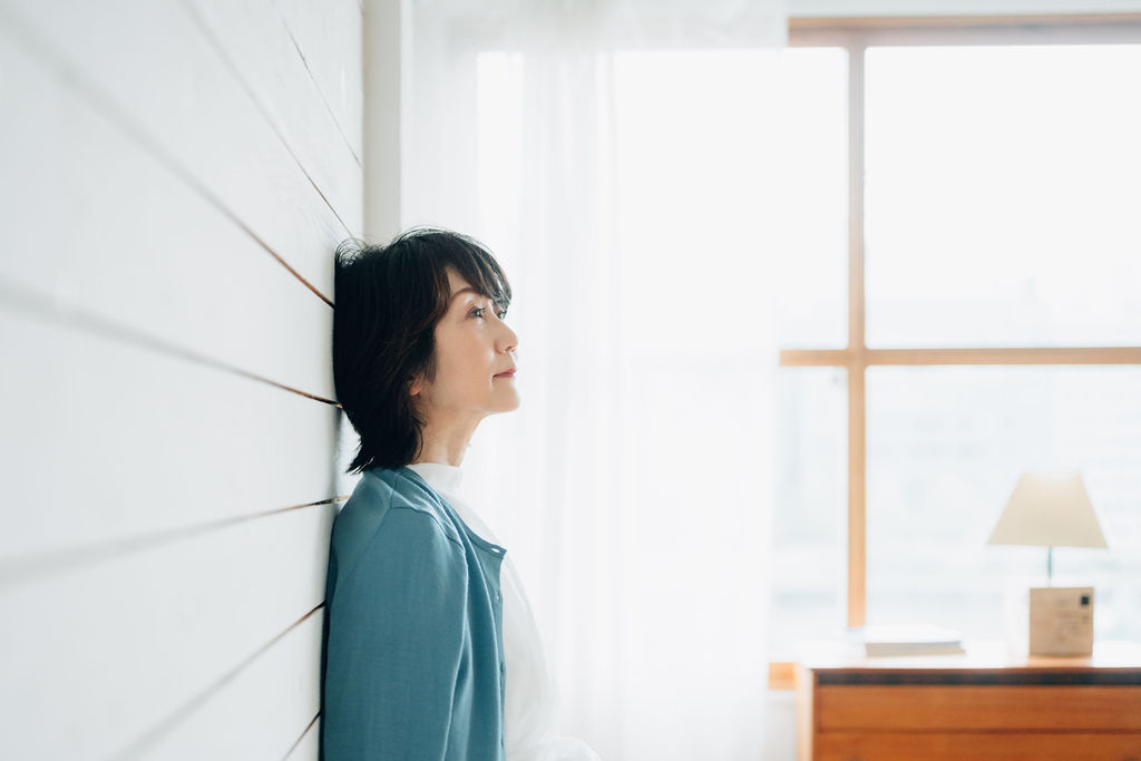 窓辺でノートを書く講師